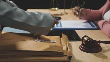 A judge is holding a paper with a pen and a laptop video