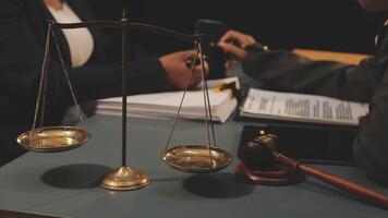 A judge scales a scale with a gavel and a paper video