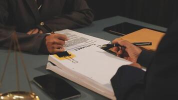 A man signing a document with a pen and a woman writing on a piece of paper video