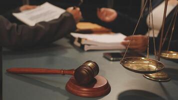 Lawyer and judge sitting at a desk with a gavel and scales video