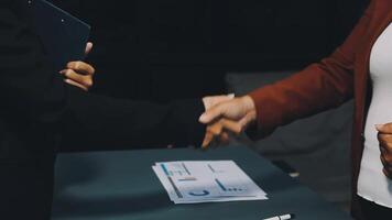 Two people shaking hands over a table video