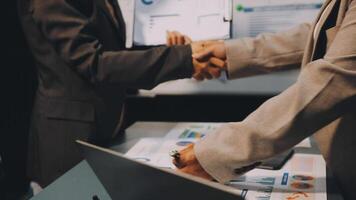 Two business people shaking hands over a table video