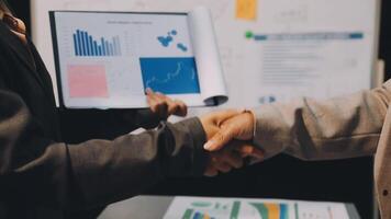 Two business people shaking hands over a piece of paper video