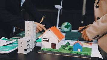 Two people are working on a model of a house video