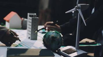 People working on a project with a wind turbine video