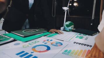 Business people working on a table with graphs and papers video