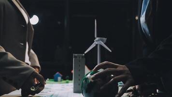 Business people working on a project with wind turbines video