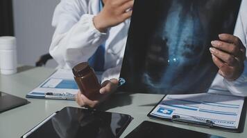Two doctors looking at an x - ray image on a tablet video