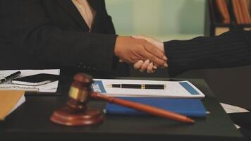 Two business people shaking hands over a desk video