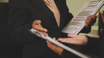 A business person is holding a document and another person is holding a clipboard video