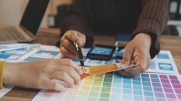 Two people working on a design project with color swatches video