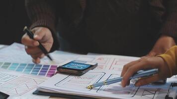 A person is working on a design project with a pen and paper video
