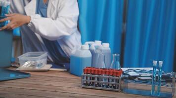 A man in lab coat is working on a table video