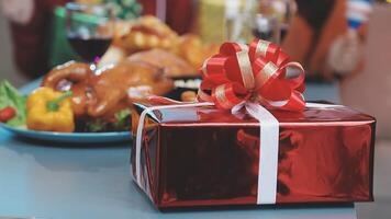 A red gift box with a bow on top of a table video