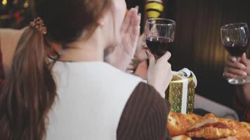 A group of people at a christmas party toasting with wine video