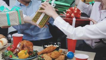 People are holding presents at a table with food video