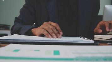 A person in a suit is working on a document video