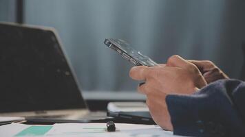 A person is using a cell phone while sitting at a desk video