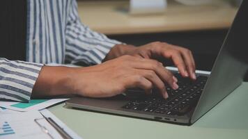 A person typing on a laptop computer video