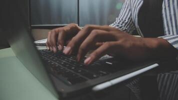 A person typing on a laptop computer video