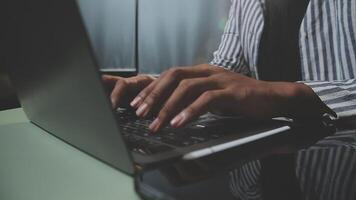 A person typing on a laptop computer video