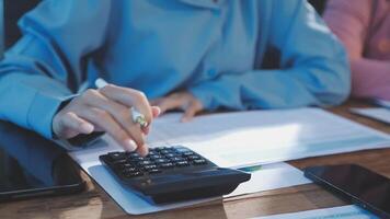 A person is using a calculator to calculate the cost of a project video