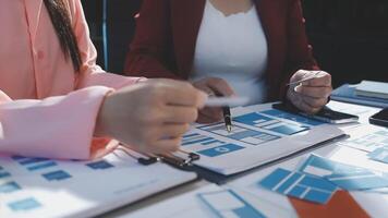 Two people working on a project with blue and red papers video
