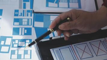 A person is using a tablet to design a website video