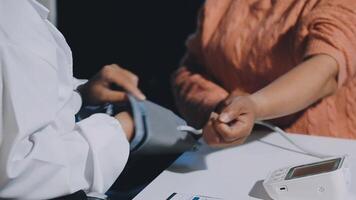 A person is checking their blood pressure with a digital device video