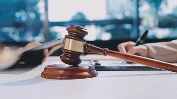 Lawyer and judge sitting at a table with a gavel video