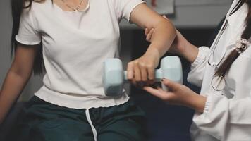 A woman is doing exercises with a dumbbell video