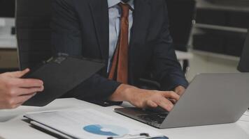 Two business people working on laptops at a desk video