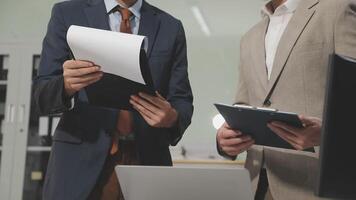 Two business men in suits holding papers video