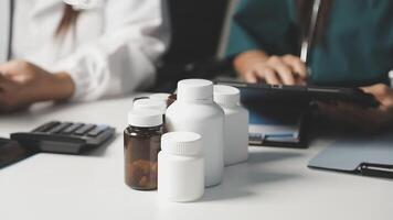 A doctor is using a tablet and a bottle of pills video