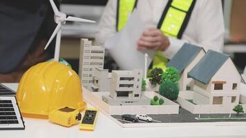 A man is working on a model of a house video