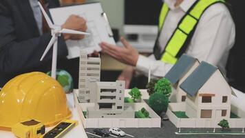 Two men are working on a model of a house video