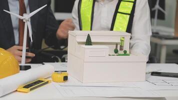 Two people working on a model of a wind turbine video