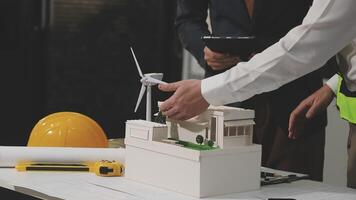 Two people working on a model of a wind turbine video