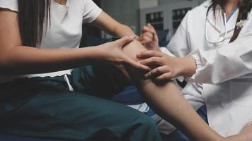 A doctor is examining a patient's knee video