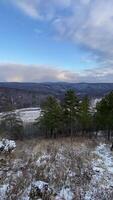 A view of a snowy landscape with trees and a river video