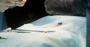 Close-up of the hands of the surgeon and assistant. The beginning of the strip operation. The doctor cuts the patient's abdomen with a scalpel. No face. 4k, red komodo video