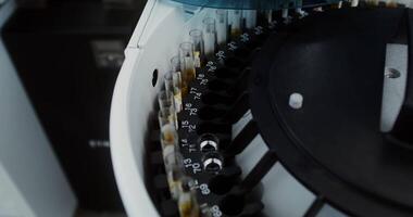 A close-up of a centrifuge in a laboratory assistant's office with blood flasks loaded into it. Carrying out a blood test in a modern clinic. 4k, red komodo video
