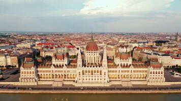 Hungarian Parliament Building in Budapest at sunset with reflection in Danube River, aerial view. Neo Gothic architecture and famous landmark of Hungary video