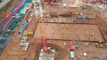 Aerial view of construction site with cranes, foundations and building materials video