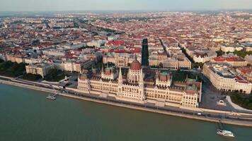 Hungarian Parliament Building in Budapest at sunset with reflection in Danube River, aerial view. Neo Gothic architecture and famous landmark of Hungary video