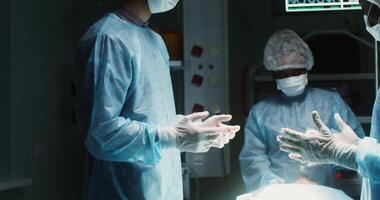 A multinational medical team is preparing for a surgical operation in a modern operating room. in 4k, red komodo video