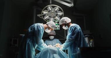Laparoscopic surgery in a modern operating room, general plan. A team of doctors perform an operation using modern medical instruments. in 4k, red komodo video