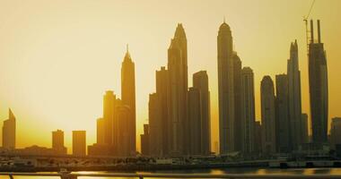 Panoramic view of Dubai City Center with glass skyscrapers on the Persian Gulf coast in the red light of the setting sun video