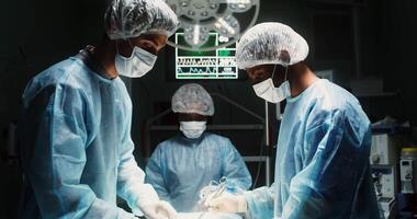 Medical team during a surgical operation in a well-equipped operating room. The assistant assists the surgeon while he chooses a medical instrument. in 4k, red komodo video