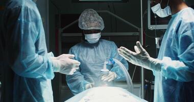 A multinational team of surgeons are preparing for the operation in a state of the operating room while waiting for the anesthesiologist's permission to perform operation. in 4k, red komodo video